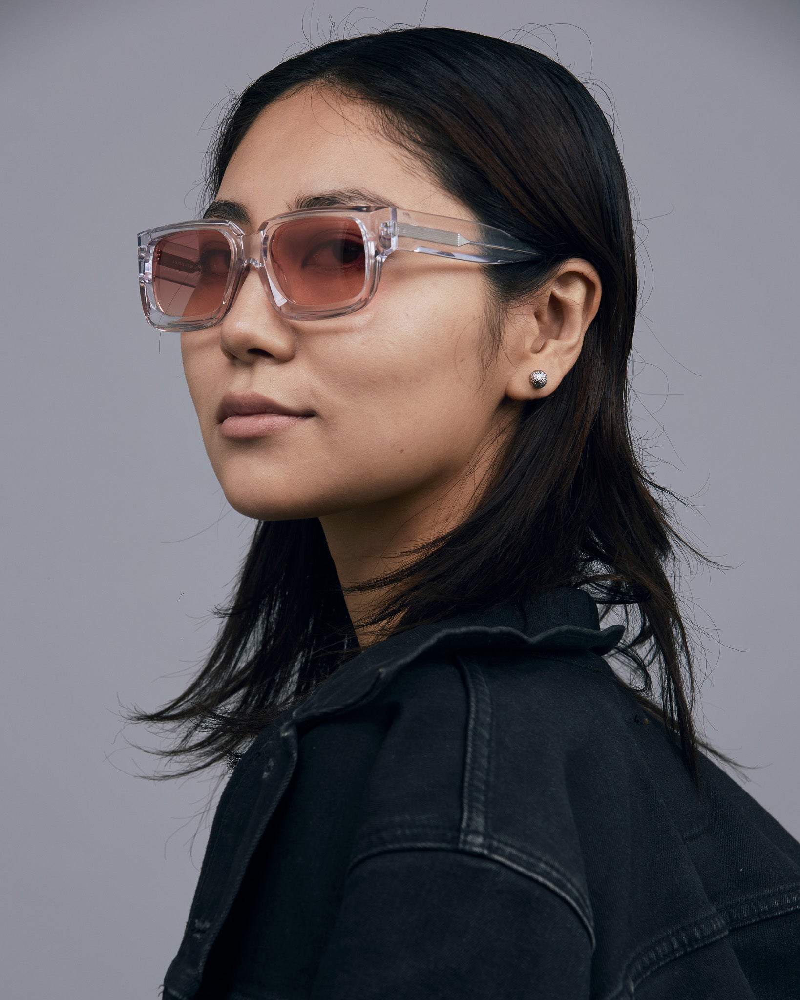 Brutal 3.0  Sunglasses by Tribu Eyewear — Crystal square acetate frame, sunset lens, female model light grey background.