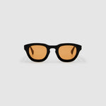 Brutal 4.0 Sunglasses by Tribu Eyewear — Black round acetate frame, desert orange lens, front view light grey background.