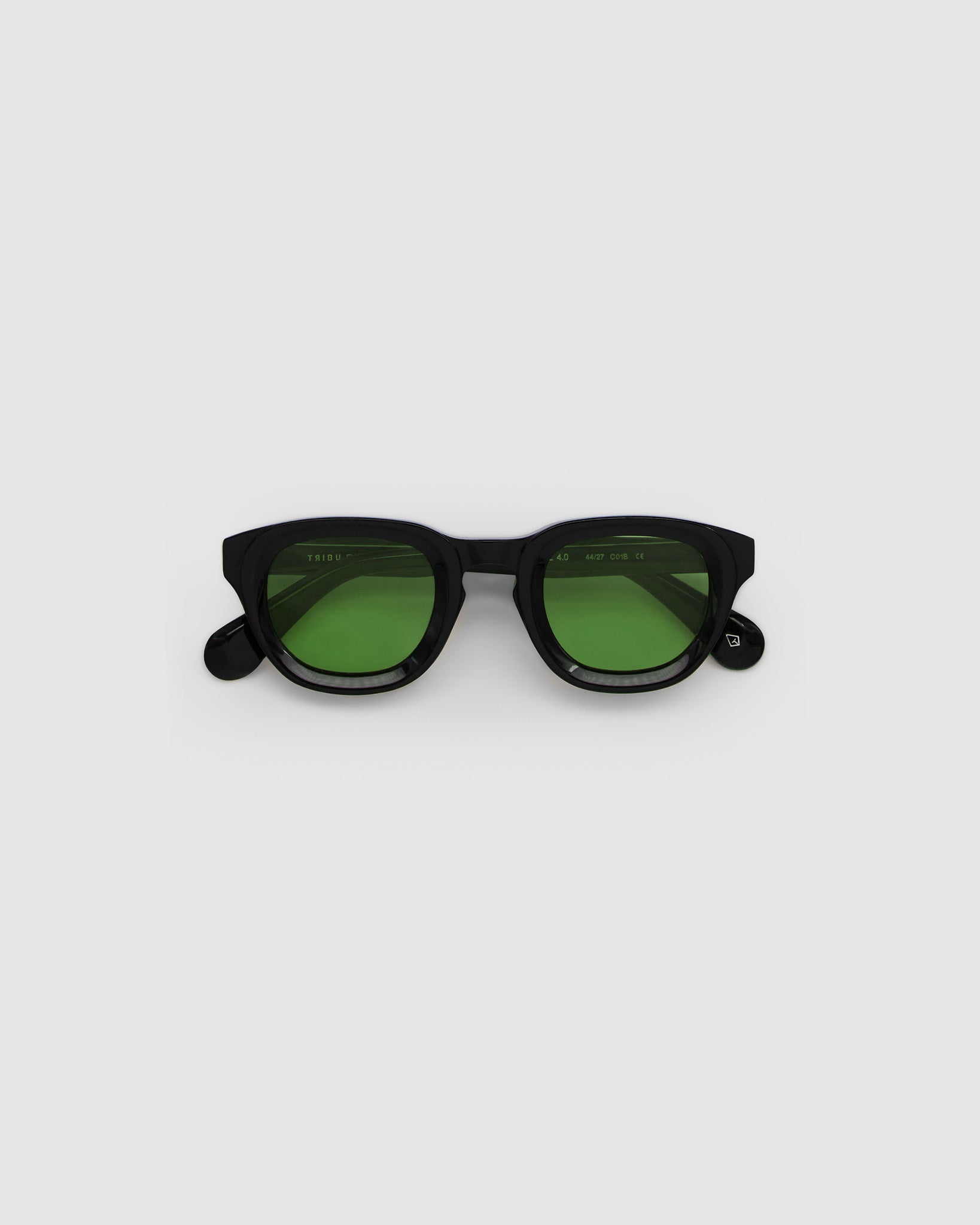 Brutal 4.0 Sunglasses by Tribu Eyewear — Black round acetate frame, sage lens, flat view light grey background.