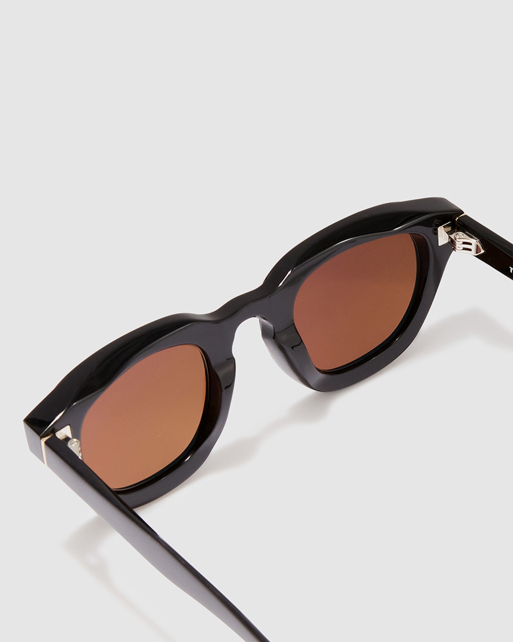 Brutal 4.0 Polarised Sunglasses by Tribu Eyewear — Black Round acetate frame, brown lens, detailed view light grey background.
