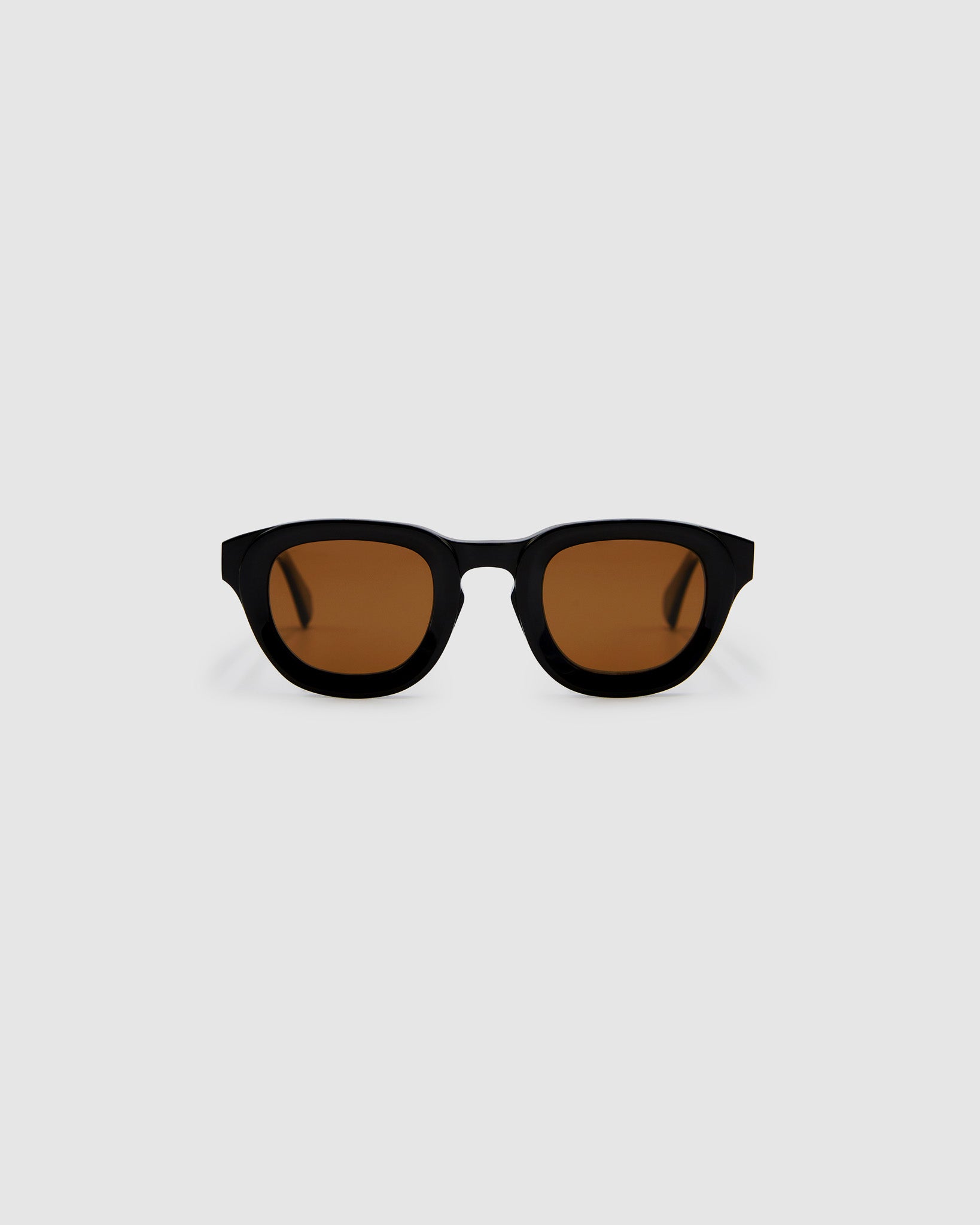 Brutal 4.0 Polarised Sunglasses by Tribu Eyewear — Black Round acetate frame, brown lens, front view light grey background.
