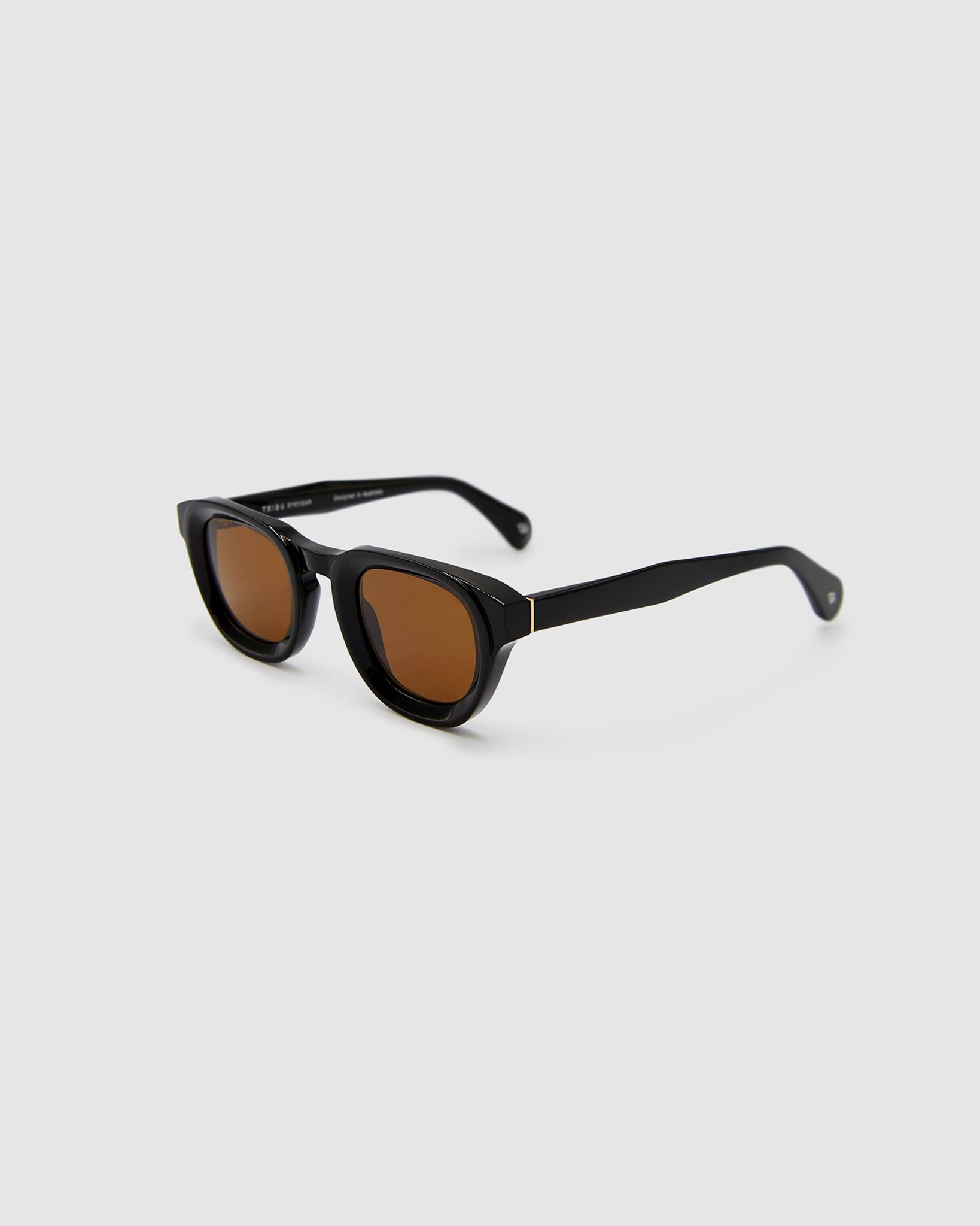 Brutal 4.0 Polarised Sunglasses by Tribu Eyewear — Black Round acetate frame, brown lens, side view light grey background.