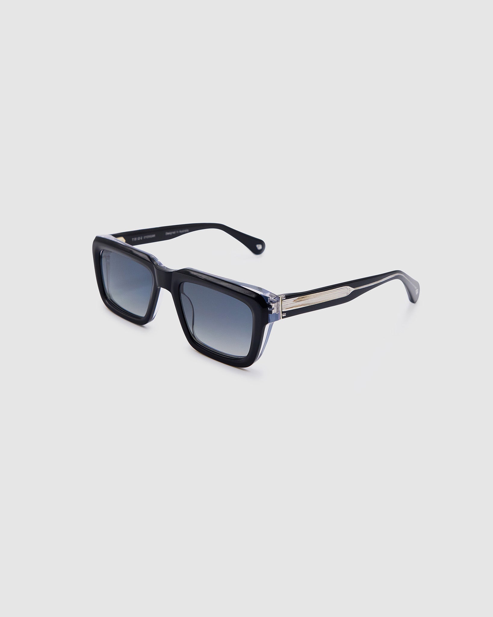 Brutal 5.0 Polarised Sunglasses by Tribu Eyewear — Black on Crystal rectangular acetate frame, grey lens, side view light grey background.
