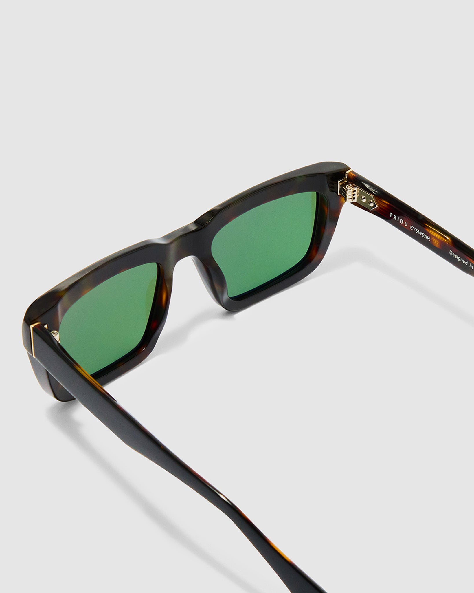 Brutal 5.0 Polarised Sunglasses by Tribu Eyewear — Black on tort rectangular acetate frame, green lens, detailed view light grey background.