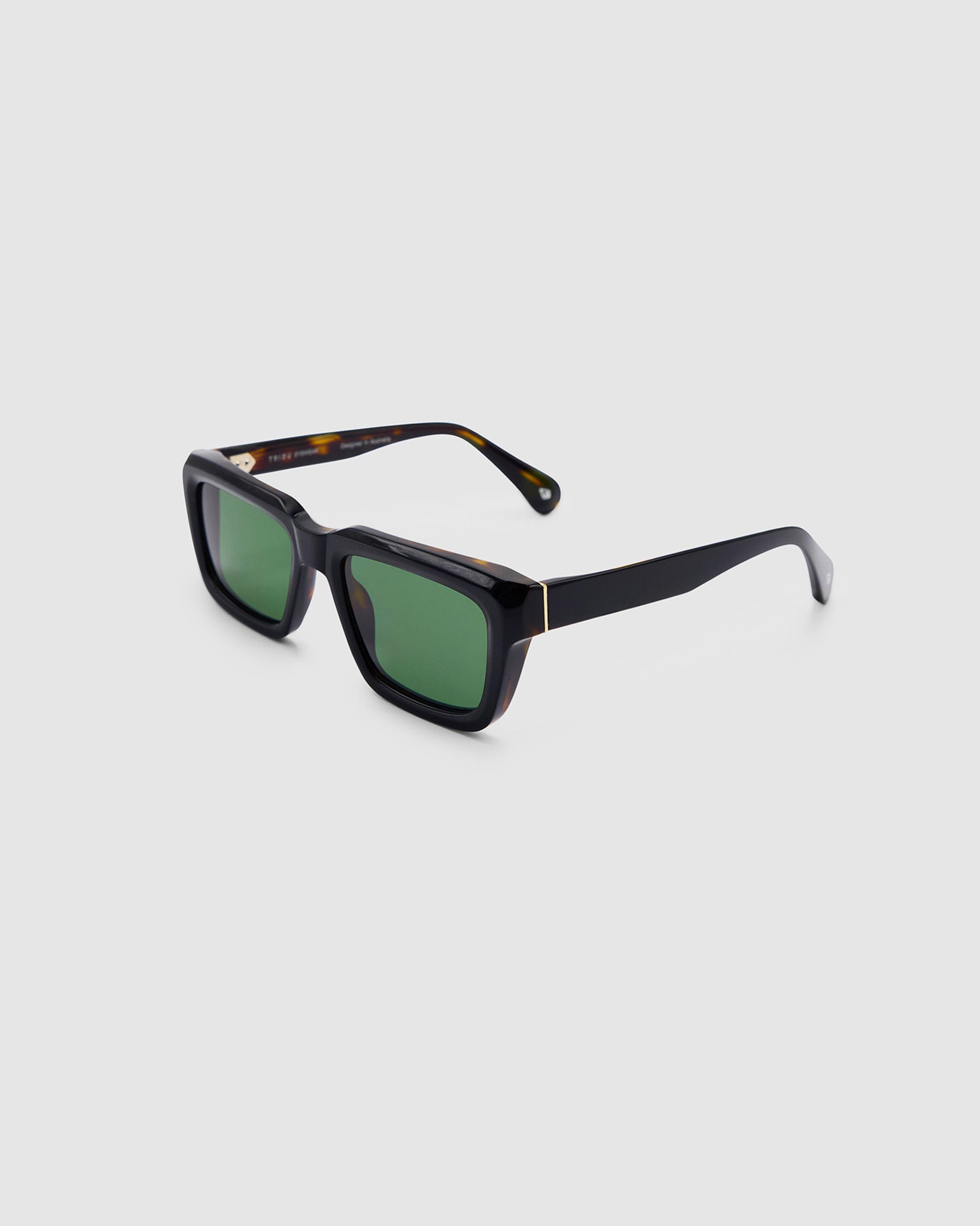 Brutal 5.0 Polarised Sunglasses by Tribu Eyewear — Black on tort rectangular acetate frame, green lens, side view light grey background.