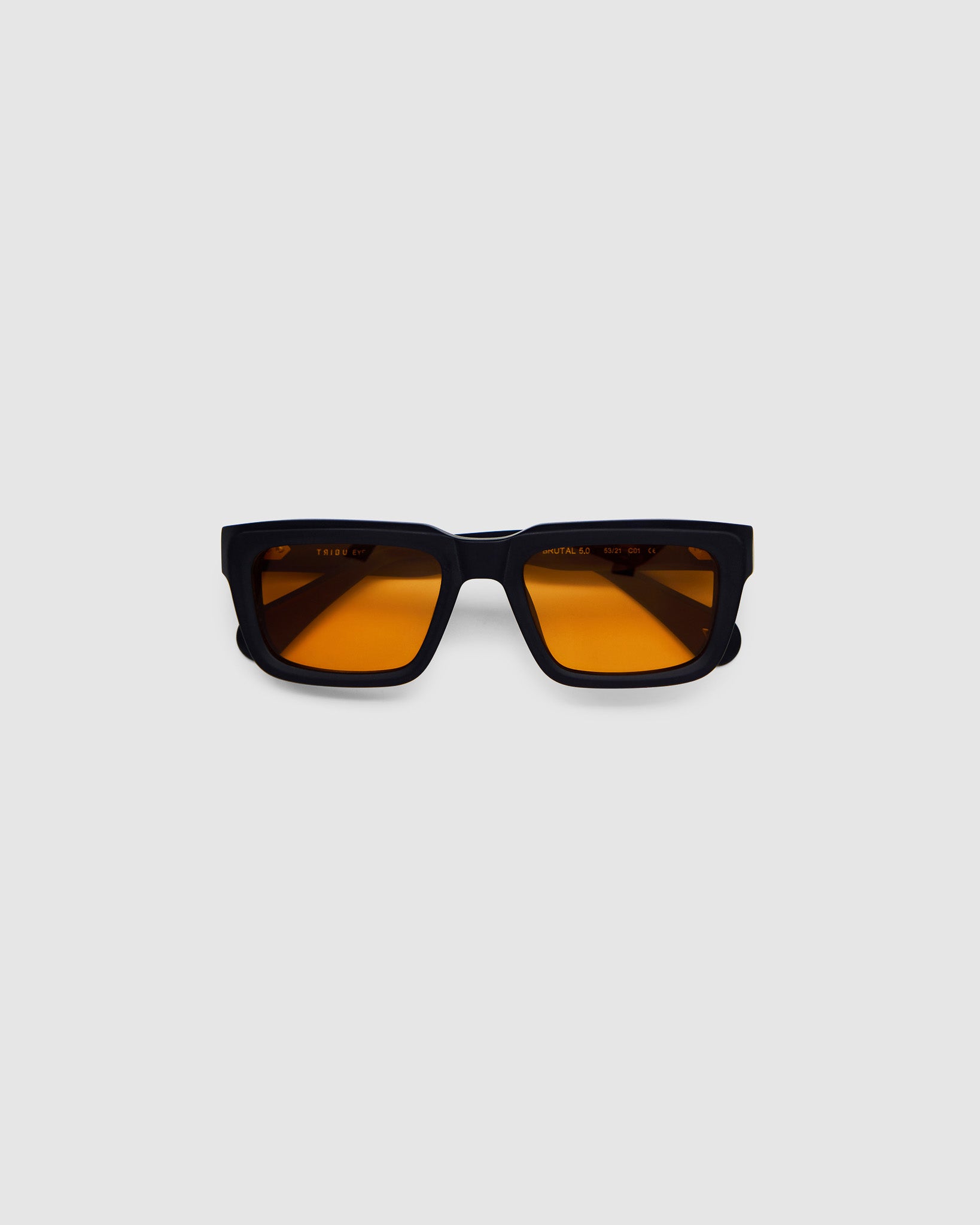 Brutal 5.0 Sunglasses by Tribu Eyewear — Matte black rectangular acetate frame, desert orange lens, flat view light grey background.