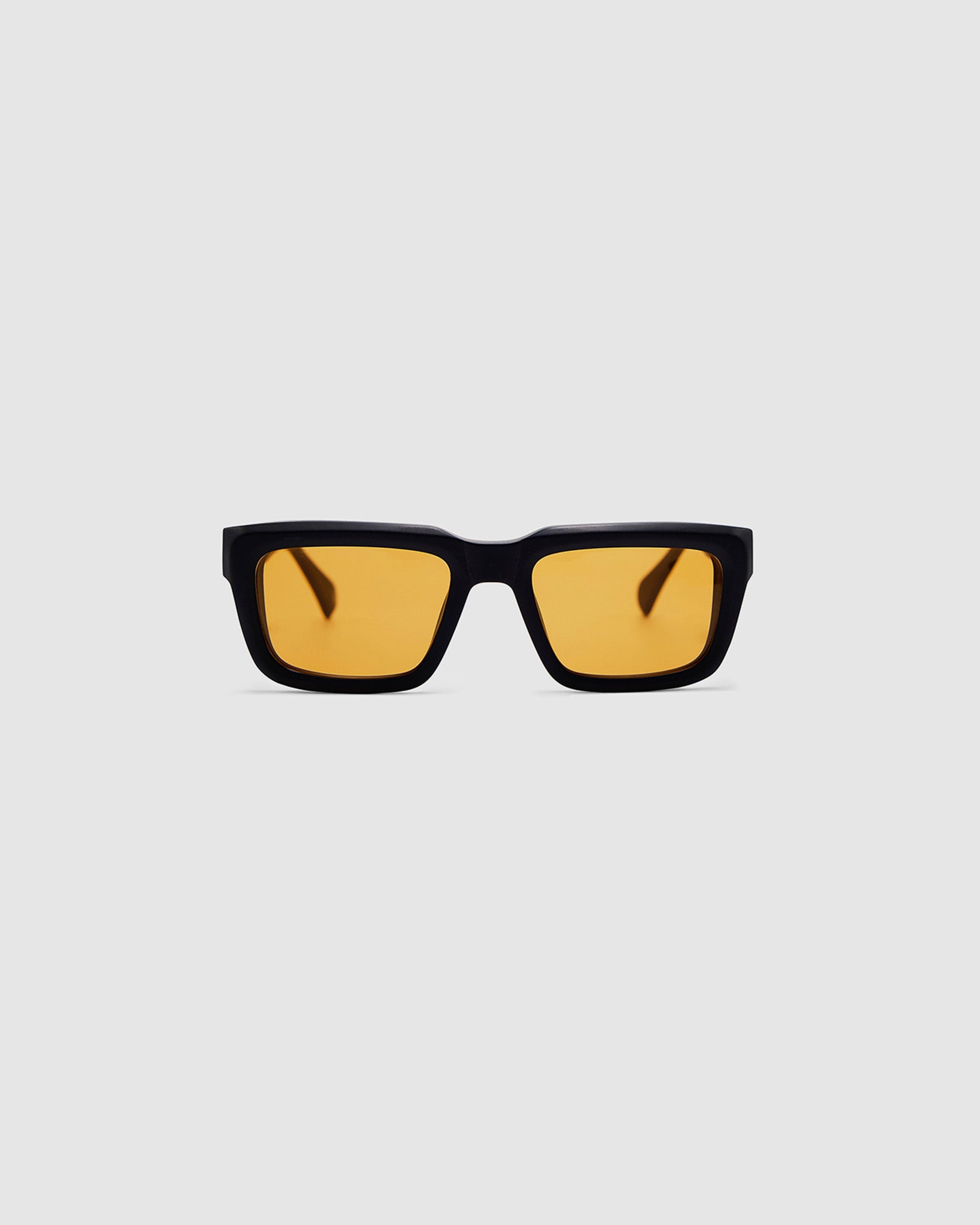 Brutal 5.0 Sunglasses by Tribu Eyewear — Matte black rectangular acetate frame, desert orange lens, front view light grey background.