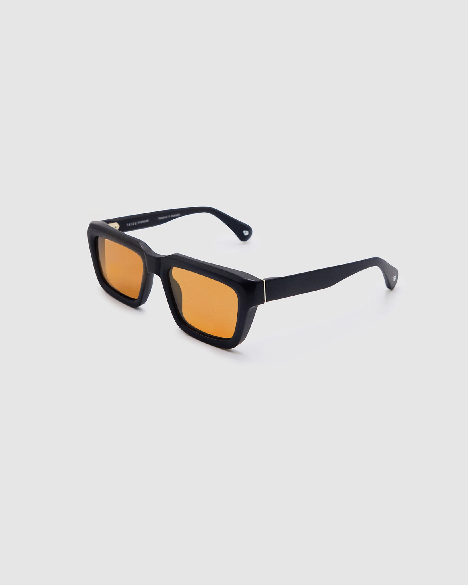 Brutal 5.0 Sunglasses by Tribu Eyewear — Matte black rectangular acetate frame, desert orange lens, side view light grey background.