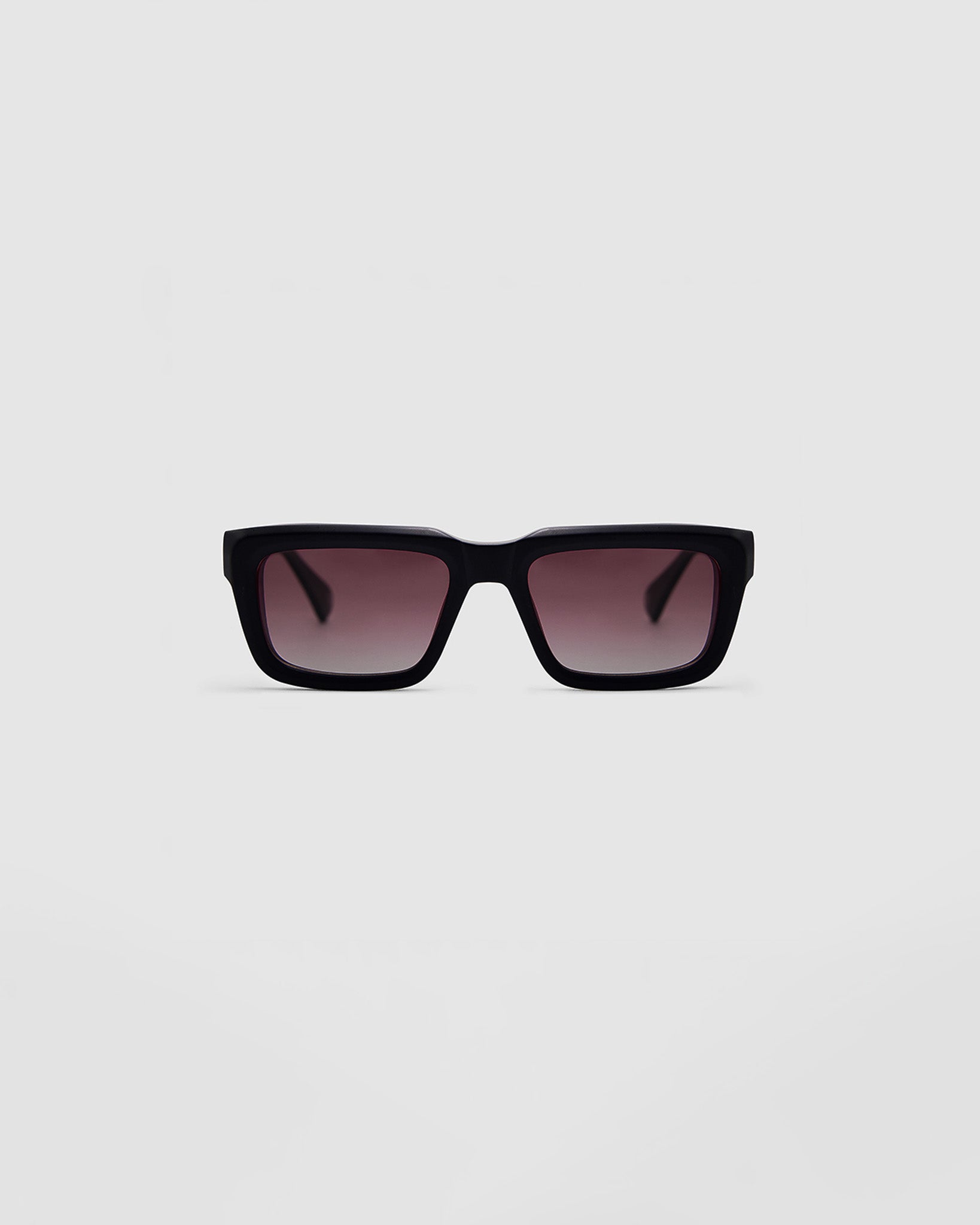 Brutal 5.0 Polarised Sunglasses by Tribu Eyewear — Matte Black rectangular acetate frame, rose grad lens, front view light grey background.