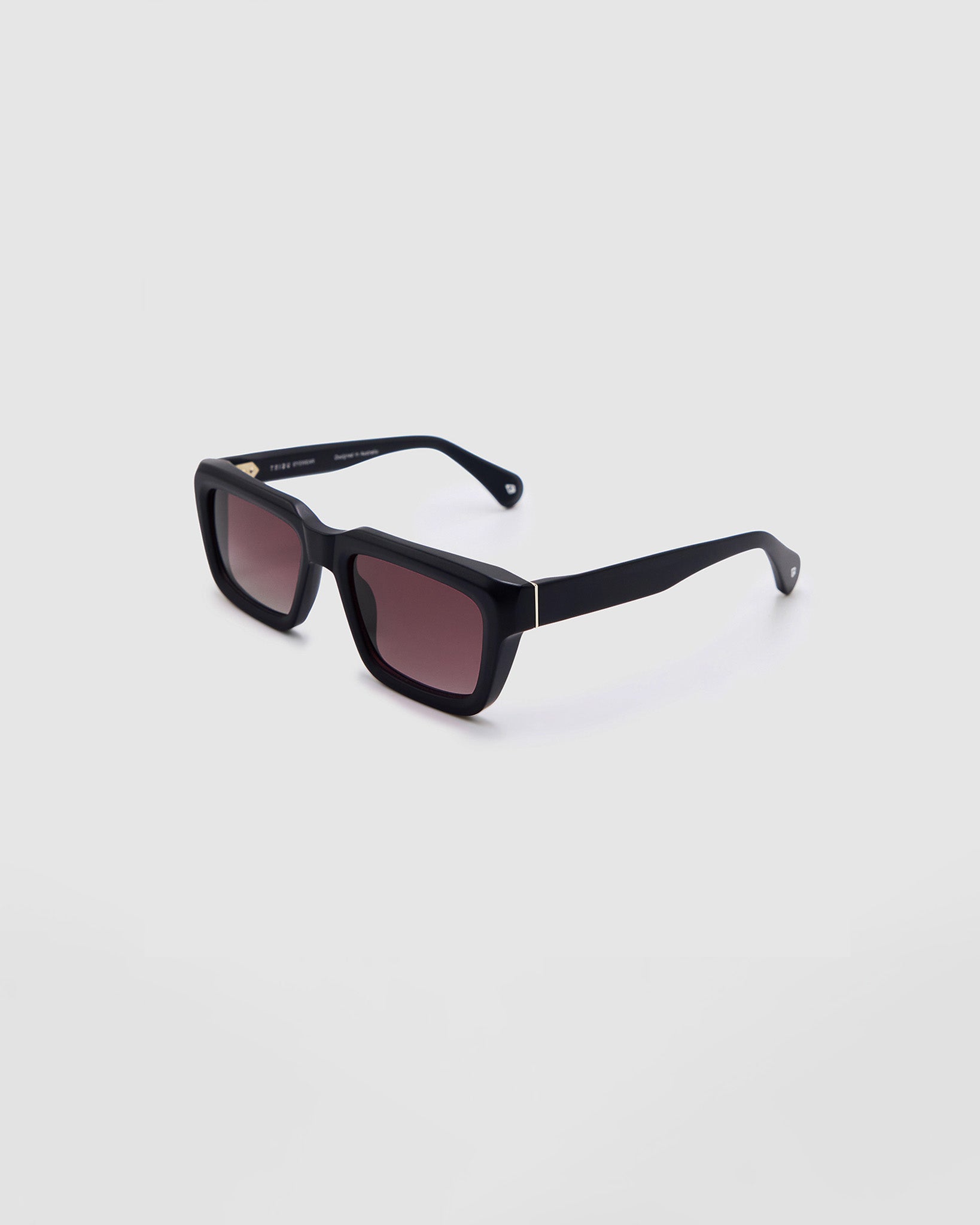 Brutal 5.0 Polarised Sunglasses by Tribu Eyewear — Matte Black rectangular acetate frame, rose grad lens, side view light grey background.