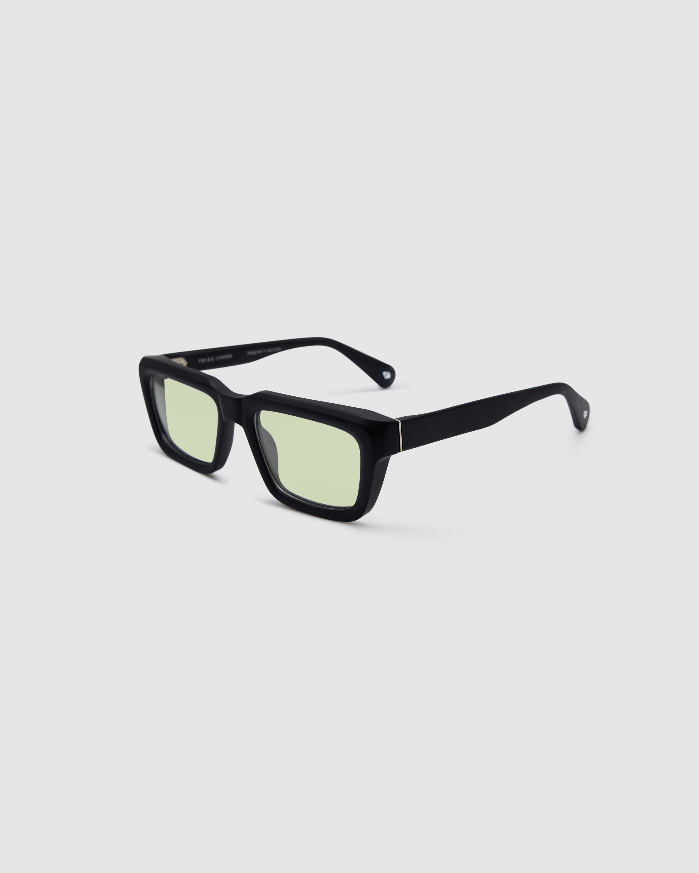 Brutal 5.0 Sunglasses by Tribu Eyewear — Matte black rectangular acetate frame, sage lens, side view light grey background.