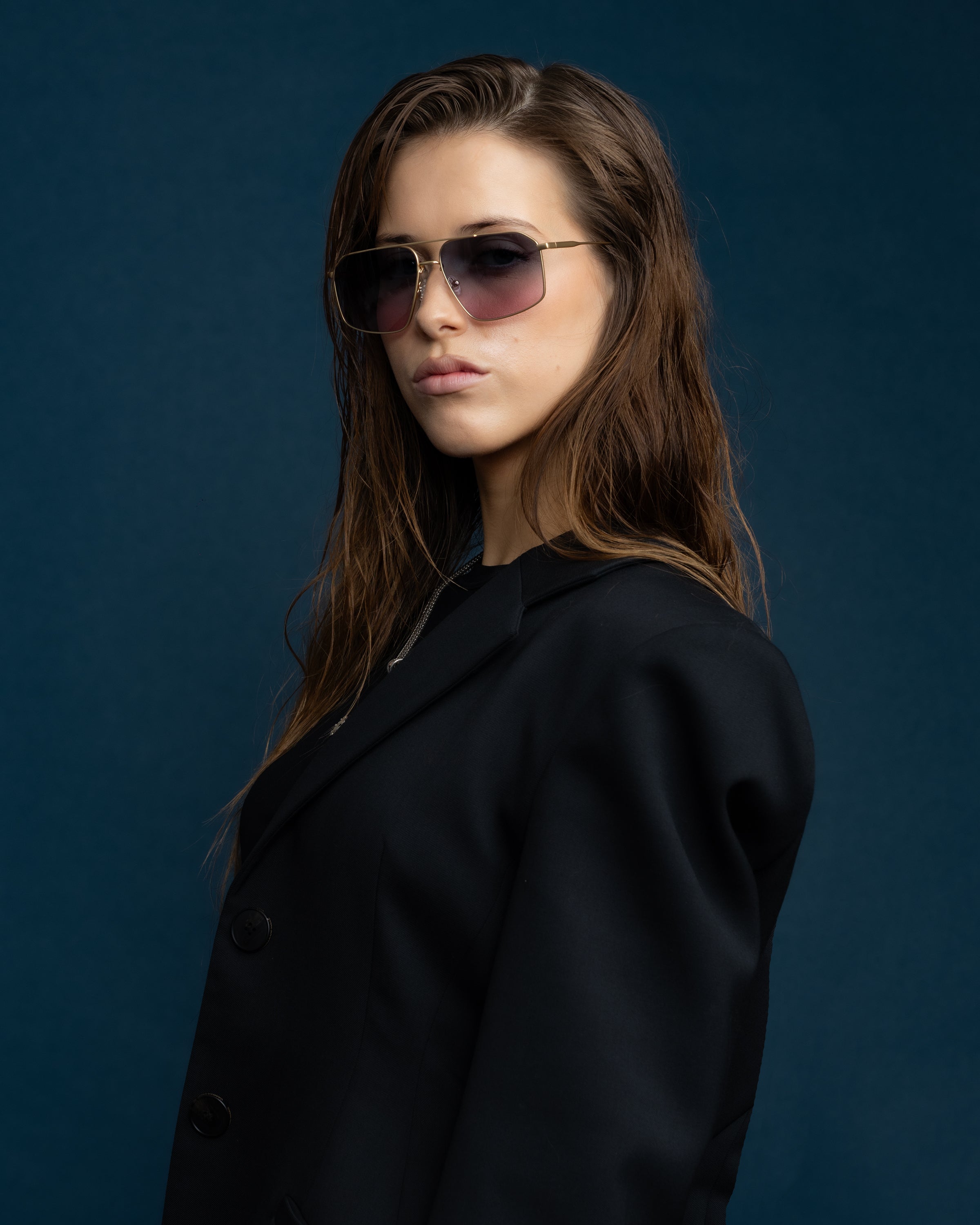 FONDA Brushed Gold Sunglasses by Tribu Eyewear — Deep Ocean, on-face studio view.