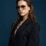 Fonda Gold Sunglasses by Tribu Eyewear  — Fine wire metal aviator frame, dusk tint on female model. 