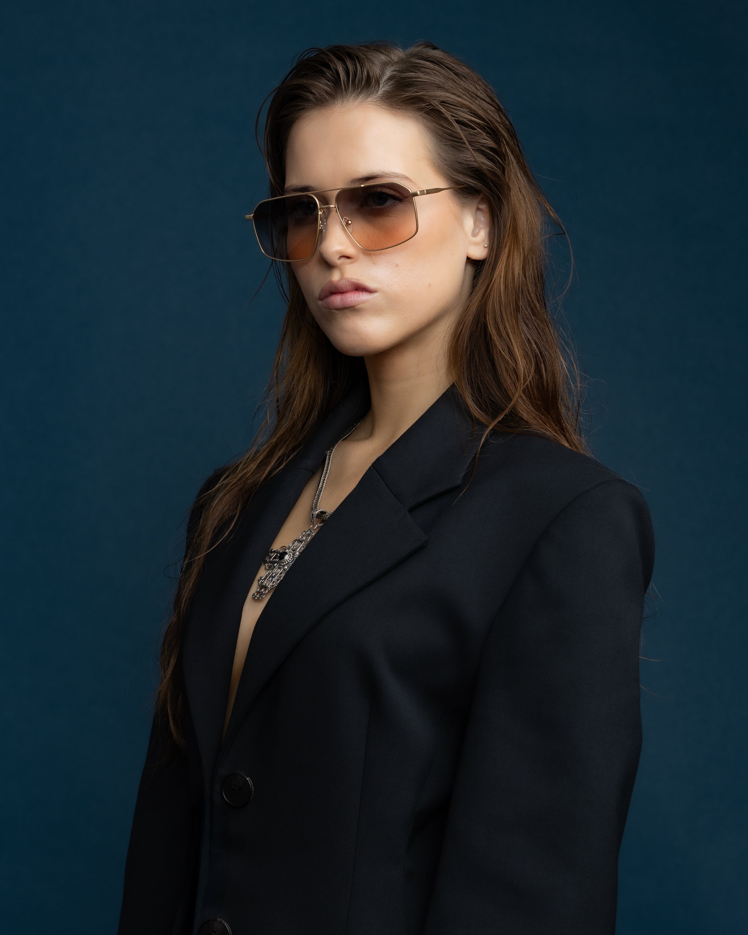 Fonda Gold Sunglasses by Tribu Eyewear  — Fine wire metal aviator frame, dusk tint on female model. 