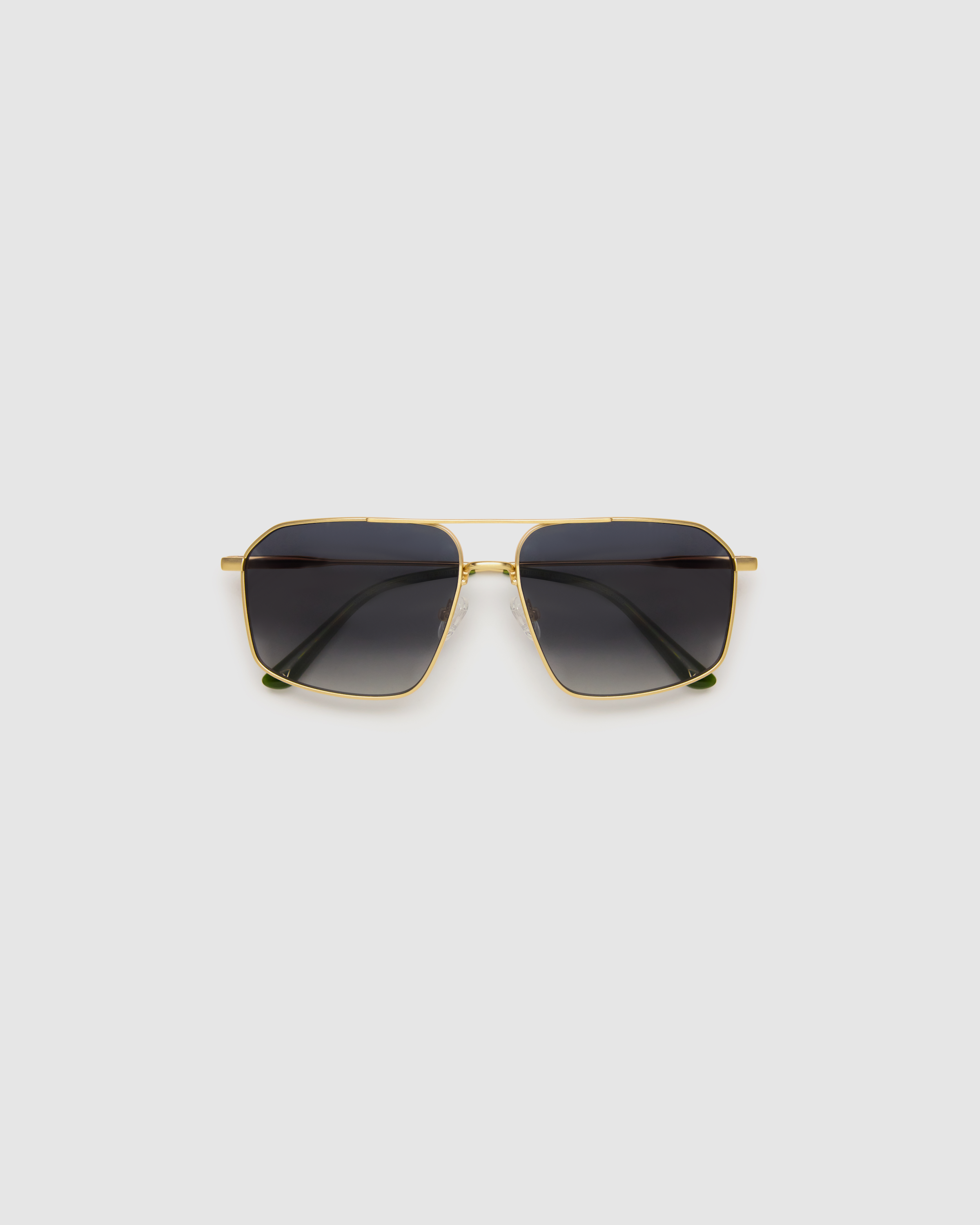 Fonda Sunglasses by Tribu Eyewear — Grey grad polarised lens in a brushed gold metal aviator frame, flat view on a grey background.
