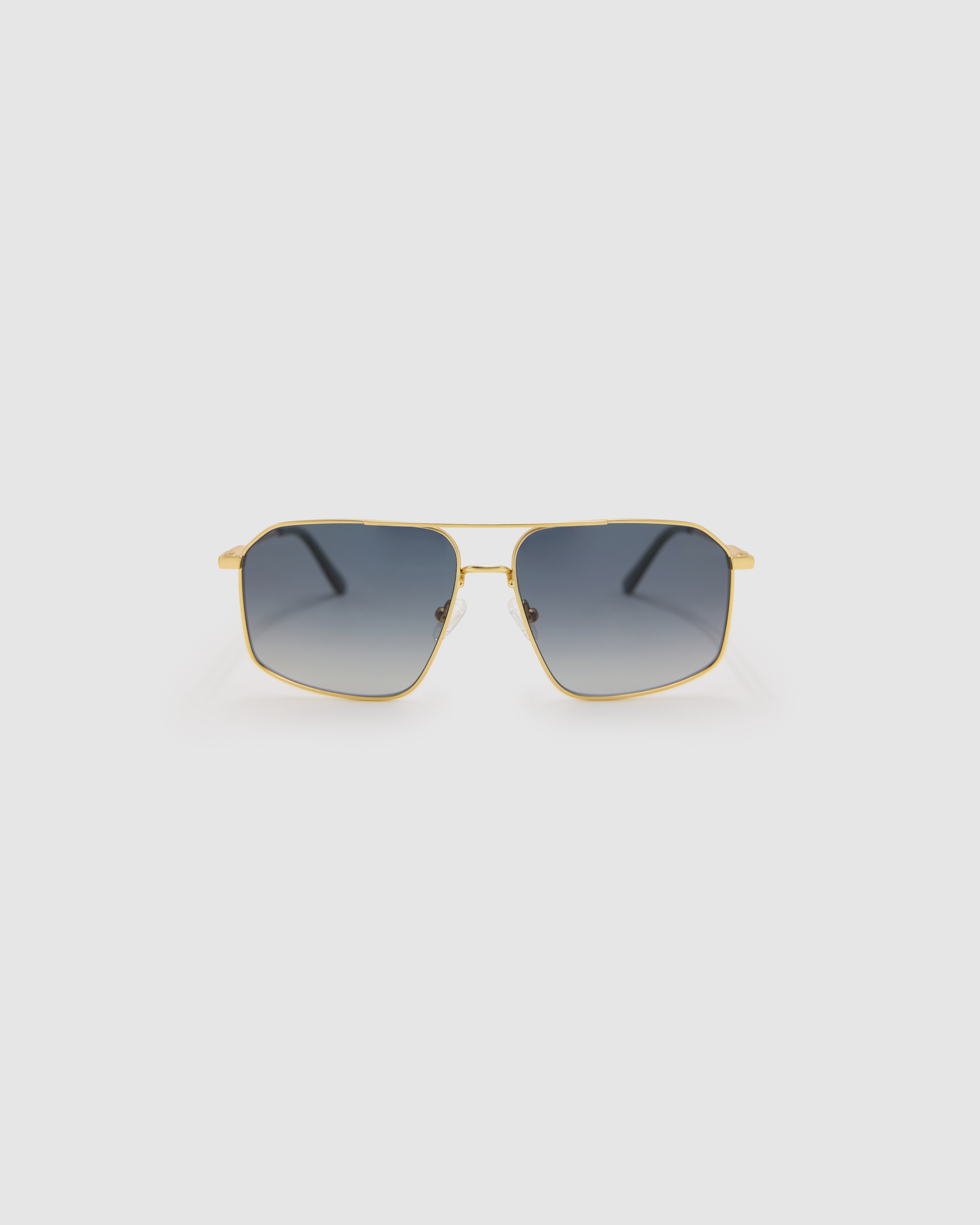 Fonda Sunglasses by Tribu Eyewear — Grey grad polarised lens in a brushed gold metal aviator frame, front view on a grey background.