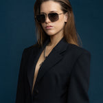 Fonda Sunglasses by Tribu Eyewear — Grey grad polarised lens in a brushed gold metal aviator frame on a female model. 