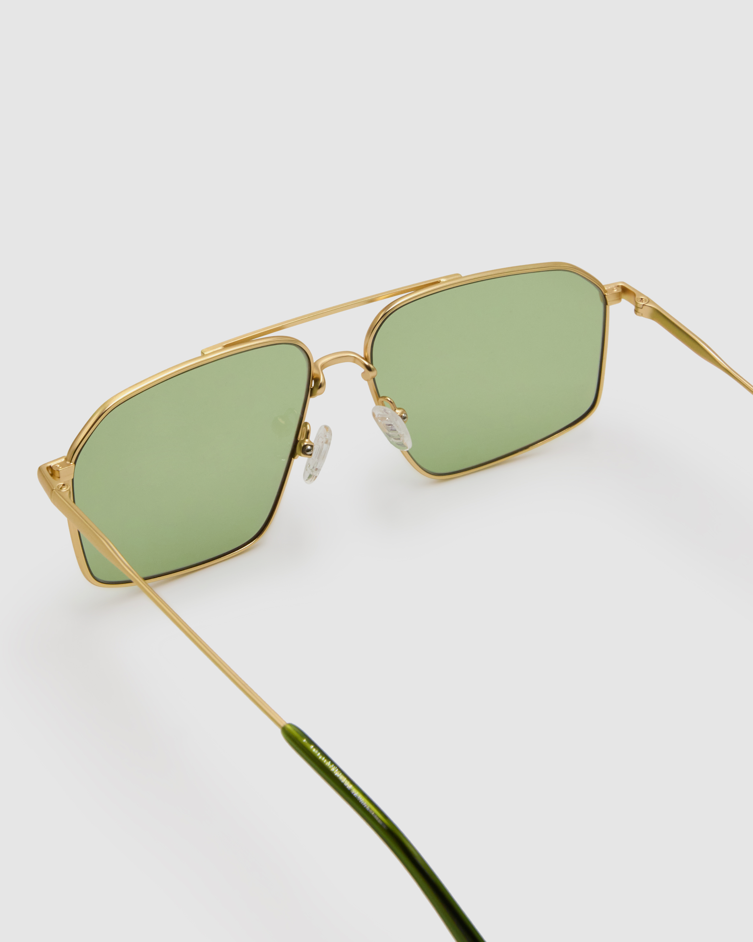Fonda Gold Sunglasses by Tribu Eyewear  — Fine wire metal aviator frame, sage lens, detailed view on white background. 