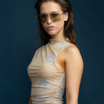 Fonda Gold Sunglasses by Tribu Eyewear  — Fine wire metal aviator frame, sage lens on female model. 