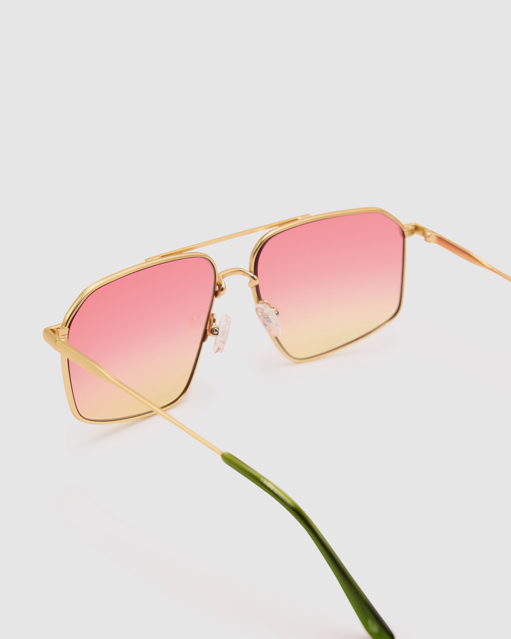 Fonda Gold Sunglasses by Tribu Eyewear  — Fine wire metal aviator frame, sunset tint lens, detailed view on white background. 