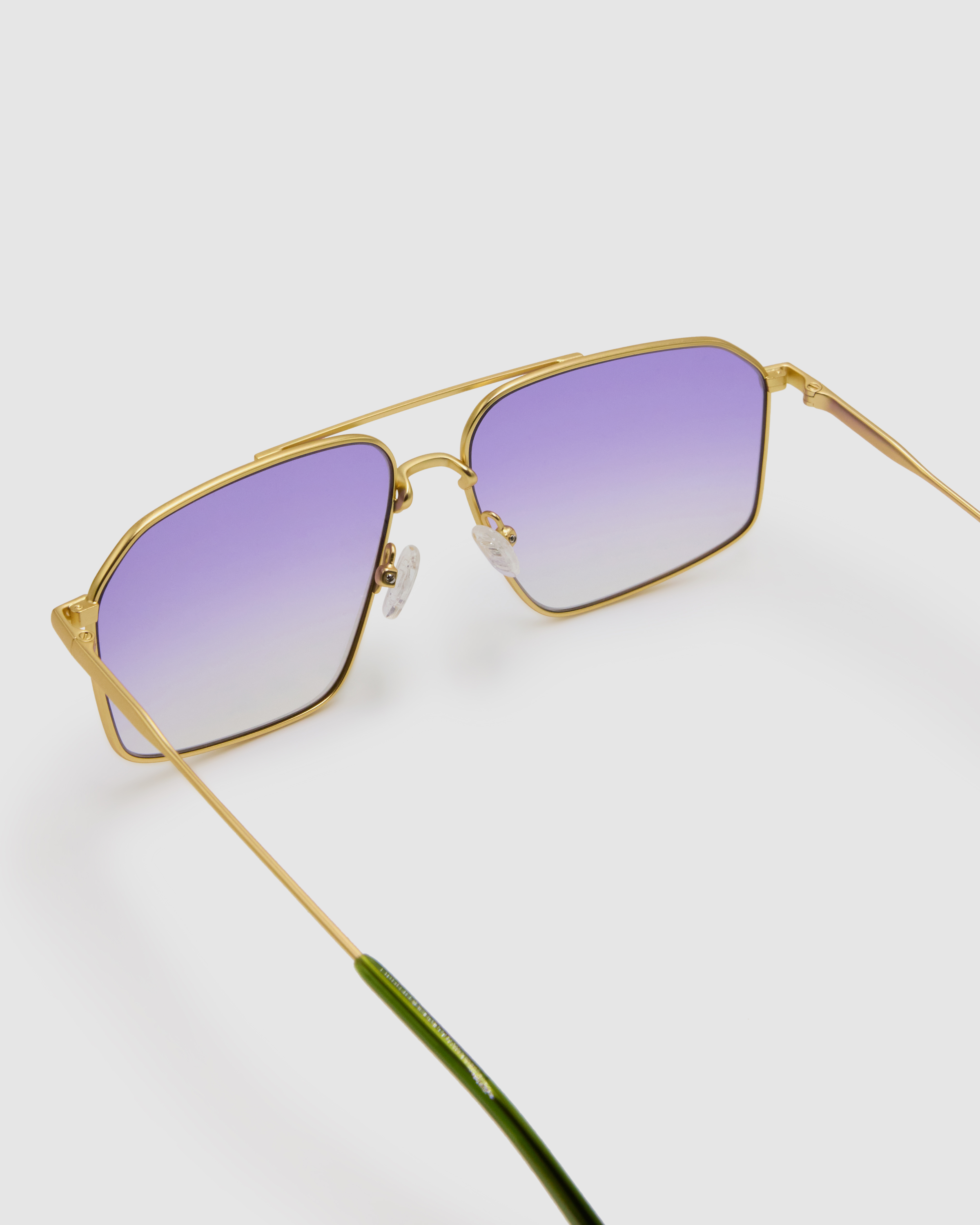 Fonda Gold Sunglasses by Tribu Eyewear  — Fine wire metal aviator frame, virgin violet lens, detailed view on white background. 