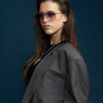 Fonda Gold Sunglasses by Tribu Eyewear  — Fine wire metal aviator frame, virgin violet lens on female model. 