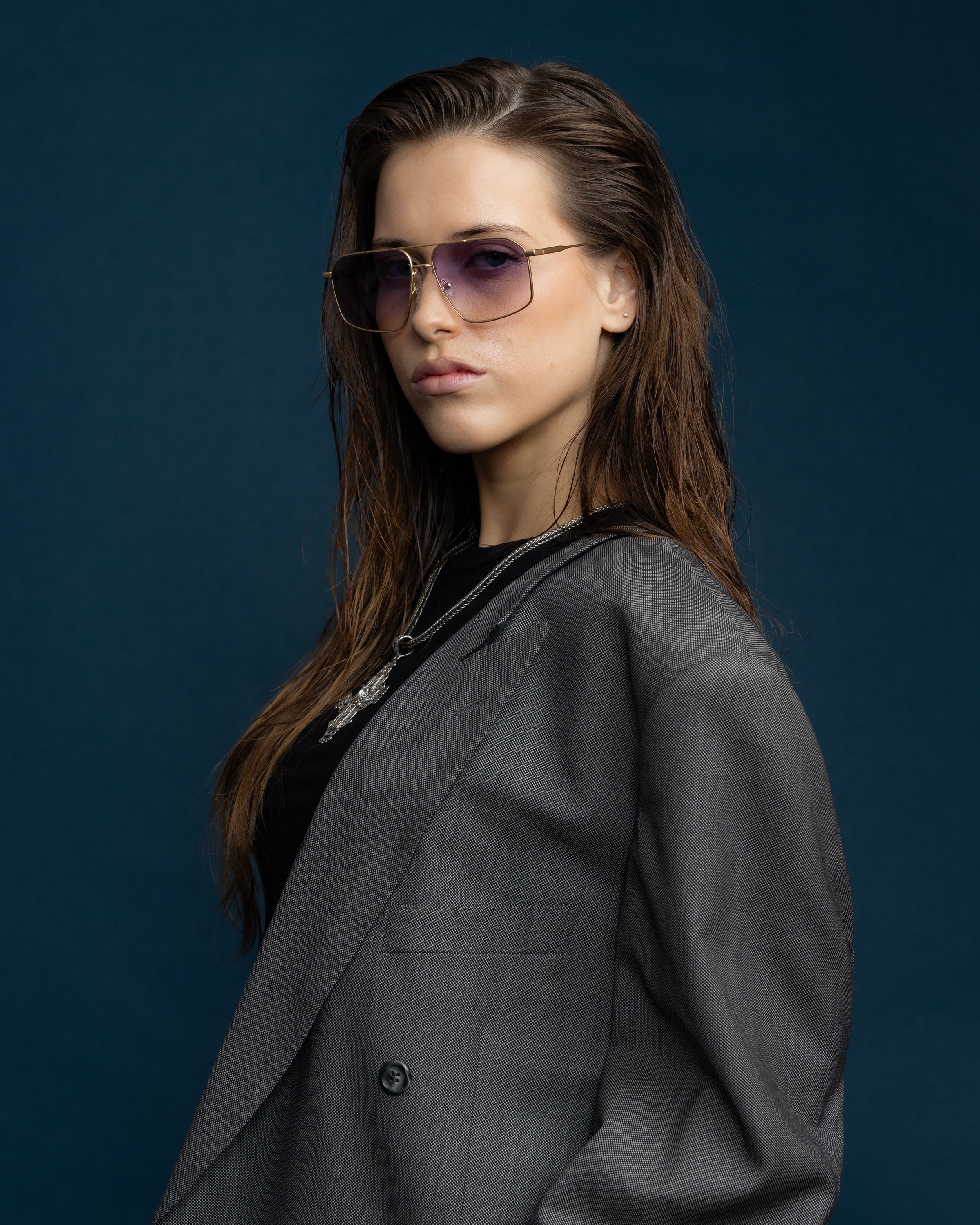 Fonda Gold Sunglasses by Tribu Eyewear  — Fine wire metal aviator frame, virgin violet lens on female model. 