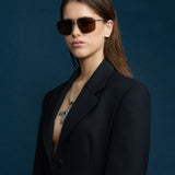 Fonda Sunglasses by Tribu Eyewear — Brown polarised lens in a gun metal aviator frame on a female model.