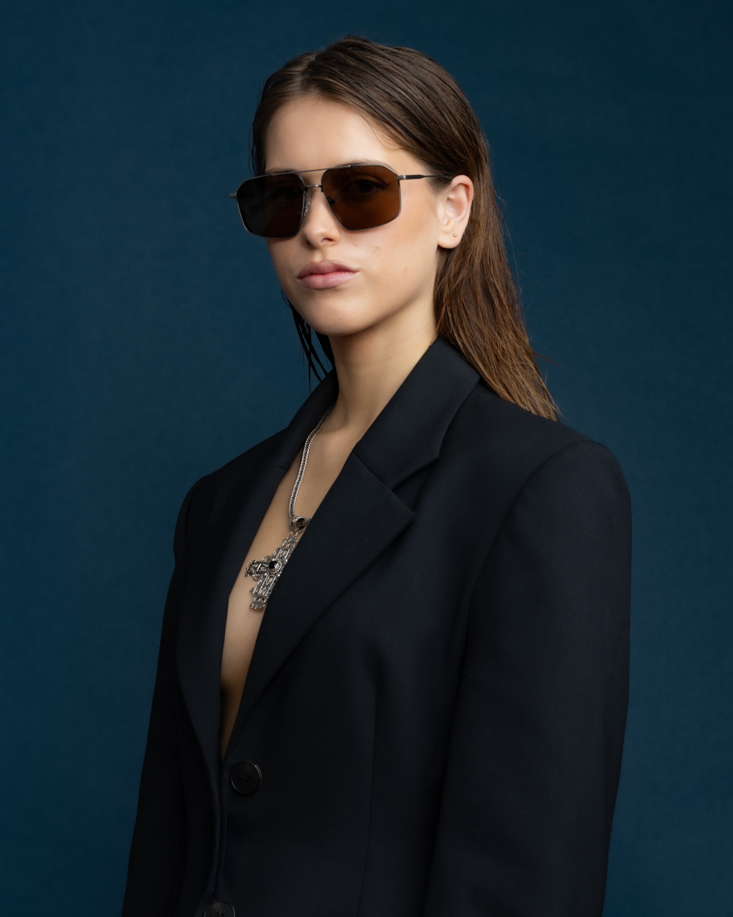 Fonda Sunglasses by Tribu Eyewear — Brown polarised lens in a gun metal aviator frame on a female model.