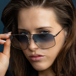 Fonda Silver Sunglasses by Tribu Eyewear  — Fine wire metal aviator frame, blue sky lens, close up female model. 