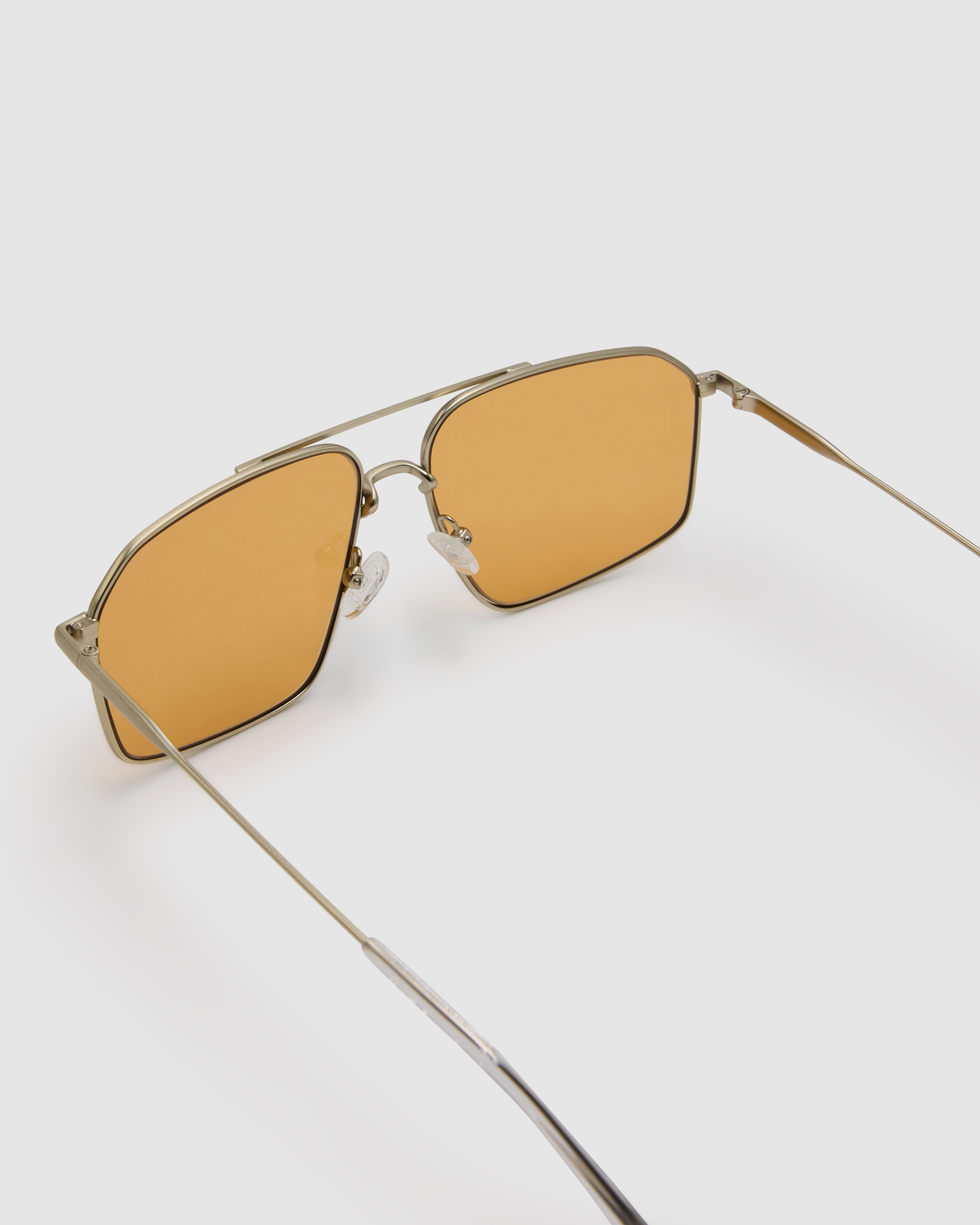 Fonda Silver Sunglasses by Tribu Eyewear  — Fine wire metal aviator frame, desert orange lens, detailed view on white background.