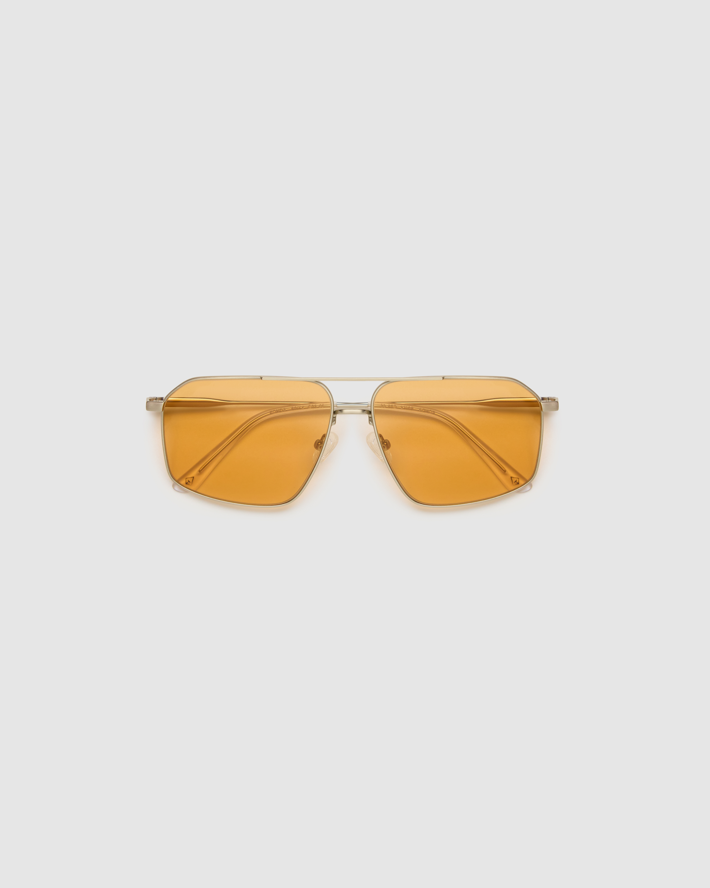 Fonda Silver Sunglasses by Tribu Eyewear  — Fine wire metal aviator frame, desert orange lens, flat view on white background.
