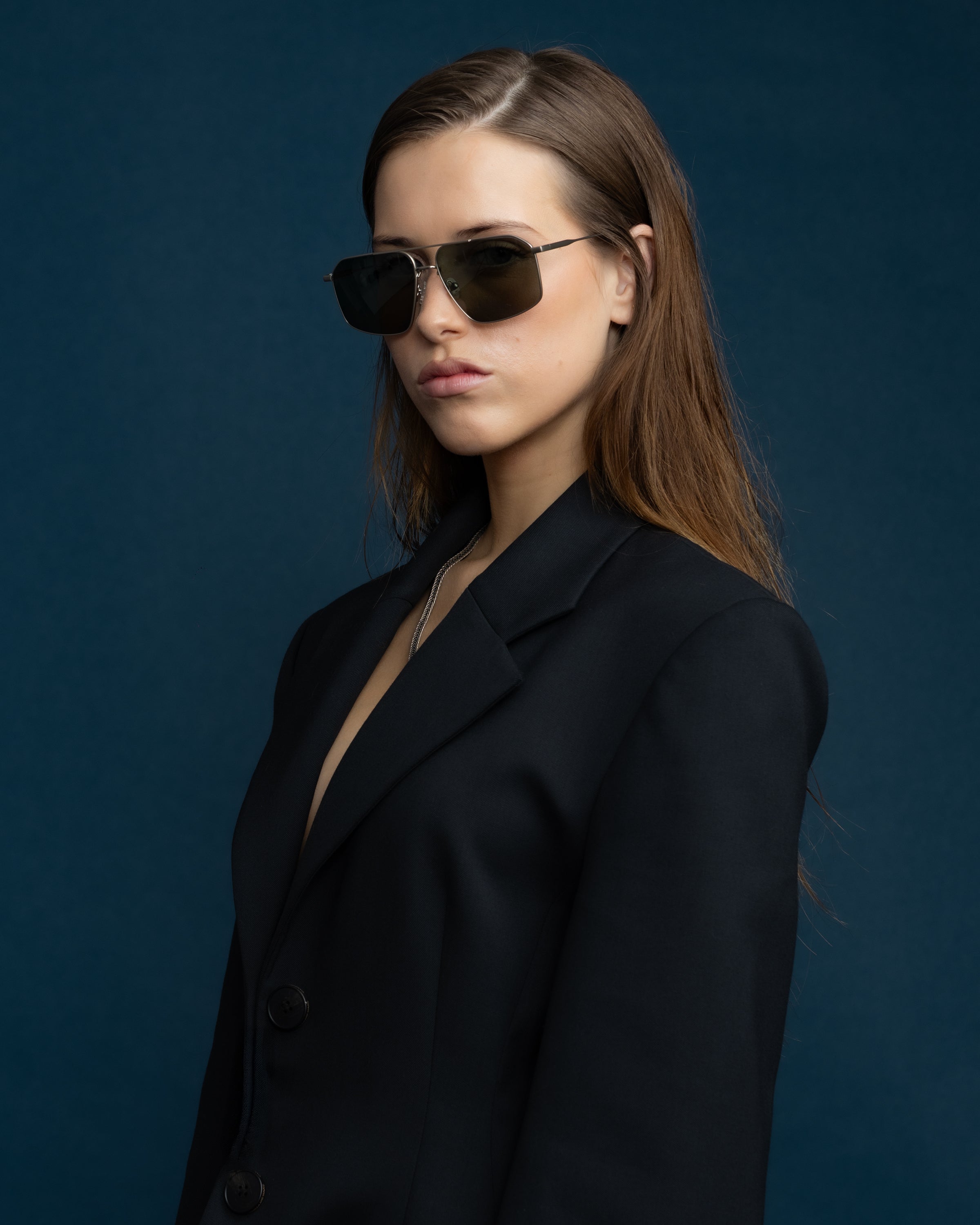 Fonda Sunglasses by Tribu Eyewear — Green polarised lens in a Silver metal aviator frame on a female model.