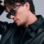 Franky Polarised Sunglasses by Tribu Eyewear — Black on Green Acetate Cat-eye frame with grey lens, side male model grey background.