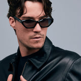 Franky Polarised Sunglasses by Tribu Eyewear — Black on Green Acetate Cat-eye frame with grey lens, male model grey background.