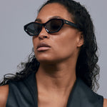 Franky Polarised Sunglasses by Tribu Eyewear — Black on Red Acetate Cat-eye frame with grey lens, female model.
