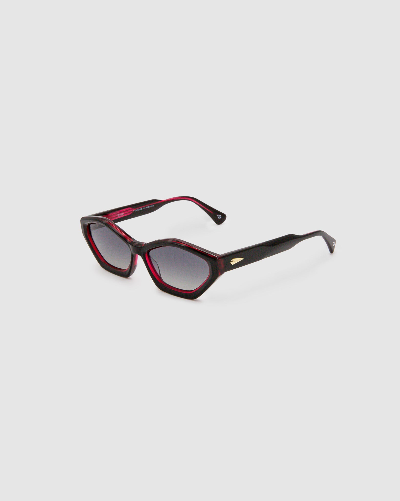 Franky Polarised Sunglasses by Tribu Eyewear — Black on Red Acetate Cat-eye frame with grey lens, side view grey background.