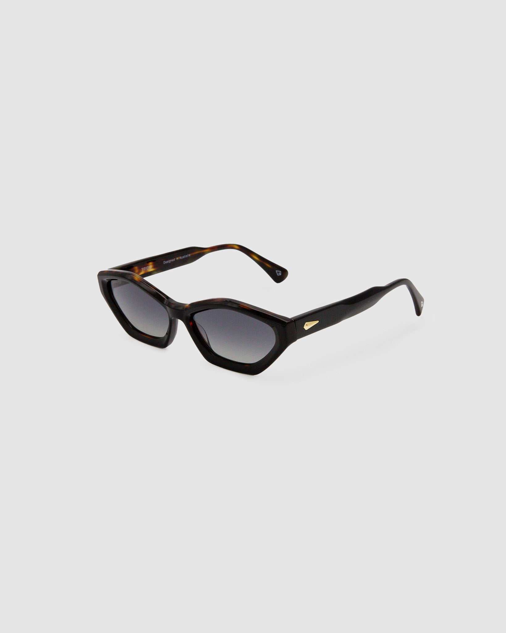 Franky Grey Polarised Sunglasses by Tribu Eyewear — Black on Tort Cat-eye frame, side view grey background.