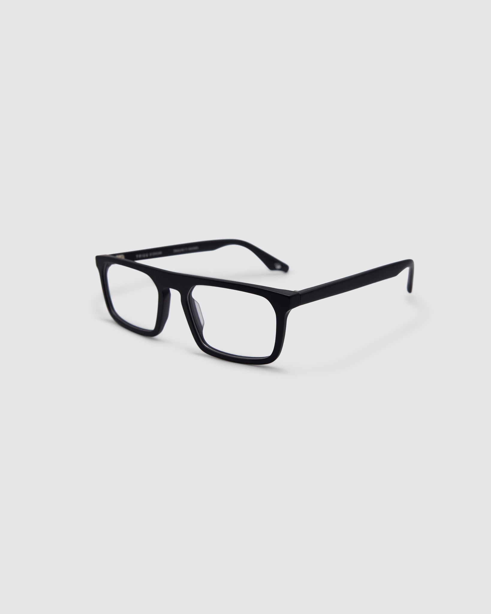 Gentleman Optical by Tribu Eyewear — matte black rectangular optical frame, side view on a grey background. 