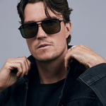 Oscar Sunglasses  by Tribu Eyewear — Metallic black aluminium aviator, green polarised lens on male model. 