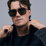 Oscar Sunglasses  by Tribu Eyewear — Metallic black aluminium aviator, green polarised lens on male model. 