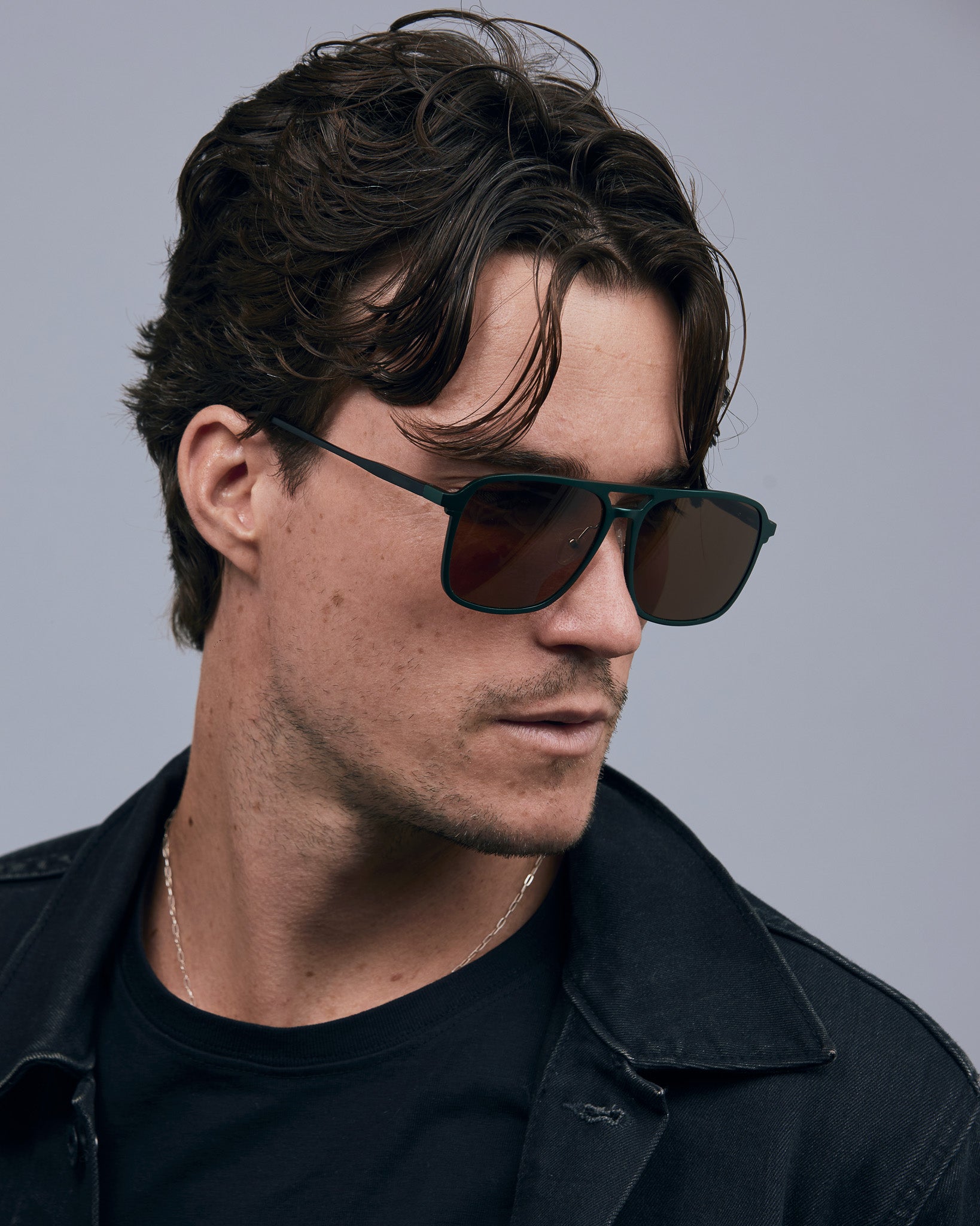 Oscar Sunglasses  by Tribu Eyewear — Forest green aviator, brown polarised lens on male model in studio. 