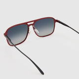 Oscar Polarised Sunglasses by Tribu Eyewear —   Metallic Burgundy Aluminium Aviator frame, grey grad lens, detailed view light grey background.