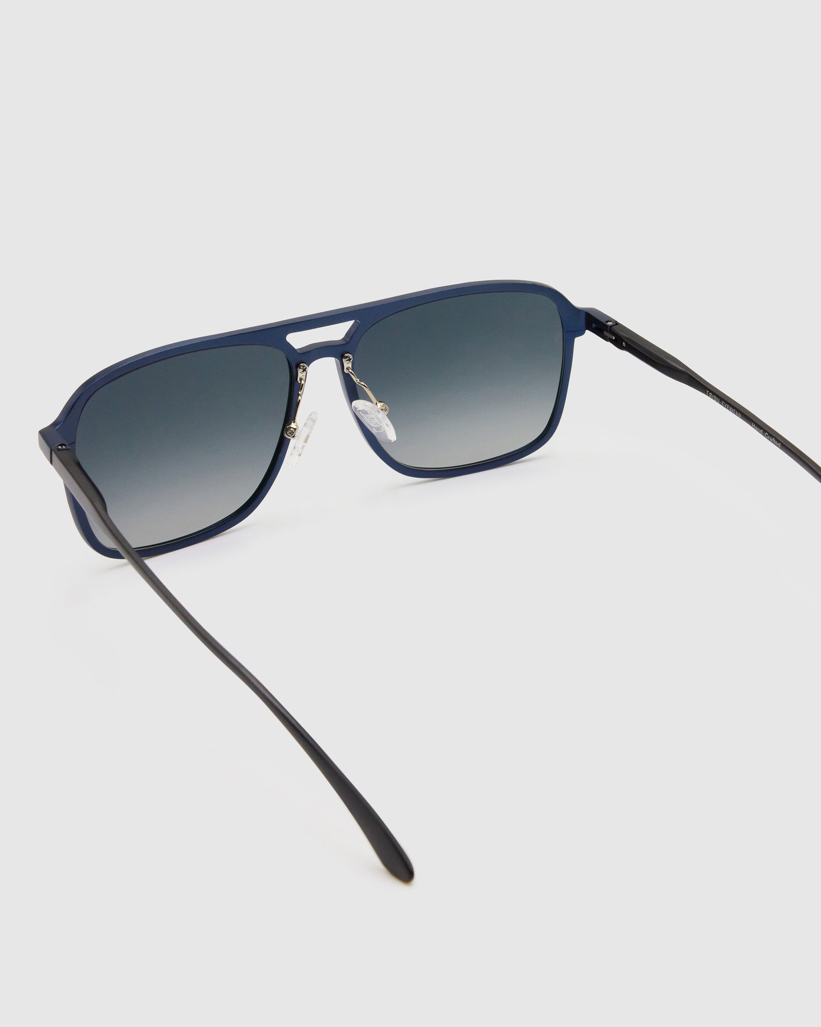 Oscar Polarised Sunglasses by Tribu Eyewear —   Midnight Blue Aluminium Aviator frame, grey grad lens, detailed view light grey background.