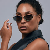 Model wearing TRIBU Nardi green and rose gold cat-eye sunglasses.